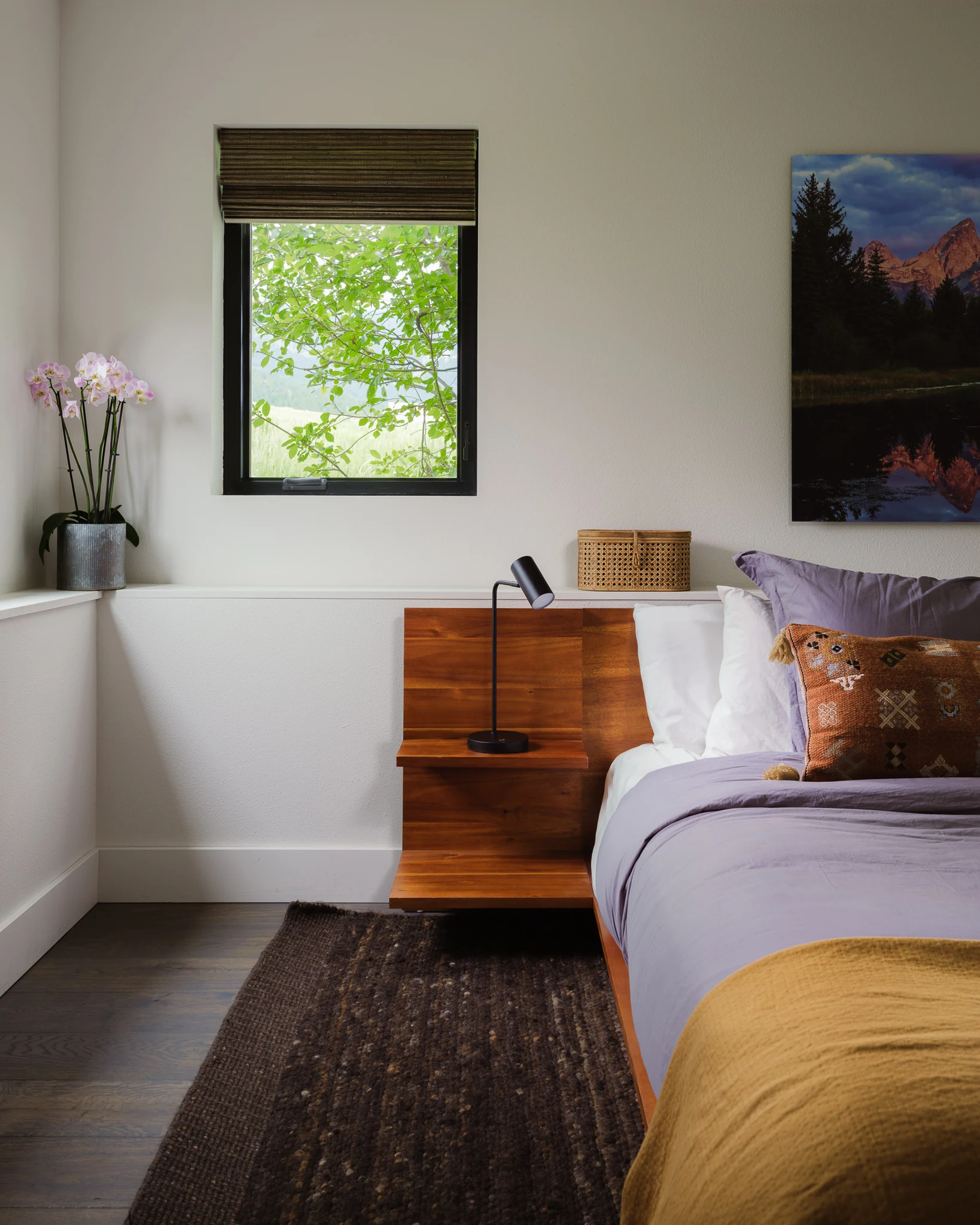 Primary bedroom nightstand styled with a mountain landscape painting — interior design photography Bozeman Montana, Living Places Design Studio